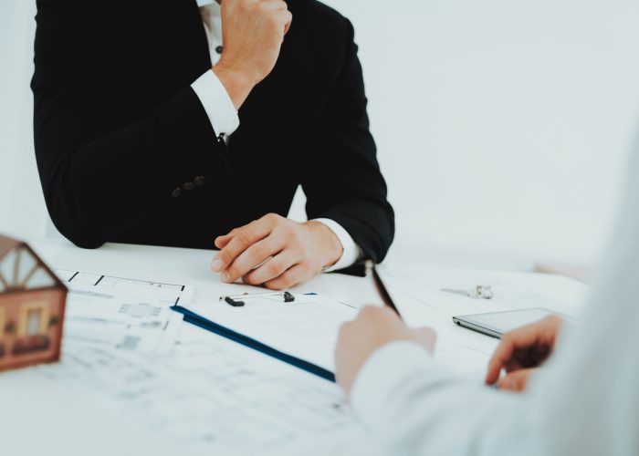 Close-up. Contract Signing Concept. Property Buy. Bright Office. Business Meeting. Customer And Buyer. Offer Discussion. Professional Agreement. House Selling Proposal. Document Signature.